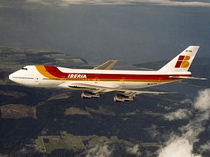 A 747-200 in Iberia livery in flight, over land