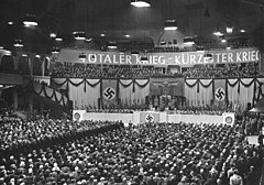 Nazi rally on 18 February 1943 at the Berlin Sportpalast; the sign says "Total War - Shortest War". Bundesarchiv Bild 183-J05235, Berlin, Grosskundgebung im Sportpalast.jpg