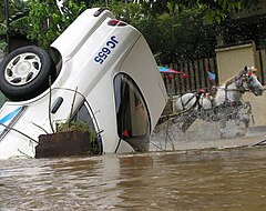 A Jakarta taxi submerged by flooded water.
