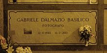 A marble gravestone on the wall of a crypt