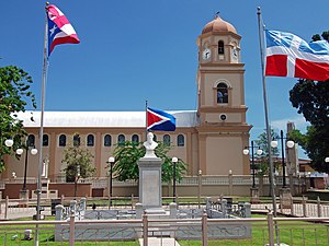 Statue of Ramón Emeterio Betances and Catholic church