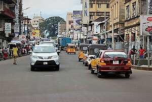 A normal day Freetown street with "Keke", regular taxis and private vehicles on the road Siaka Stevens Street, Freetown.jpg