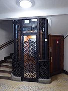 L'ascenseur et sa grille Art Déco.