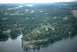 Småorten Borgvik med Borgviksjön i förgrunden och Lilla Värmeln i bakgrunden.