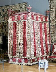 Four-poster bed from the Château d'Effiat; c.1650; natural walnut, chiselled Genoa silk velvet and embroidered silks; 295 cm; Louvre[125]
