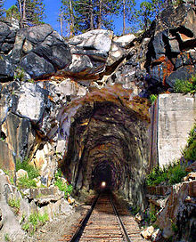 The 1,659-foot (506 m) Donner Pass Summit Tunnel (#6) was in service from 1868 to 1993. Donner Pass Summit Tunnel West Portal.jpg