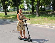 Riding an electric kick scooter in Berlin (2014) Female rider on Egret One eScooter.jpg