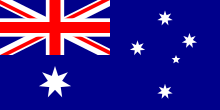 Fond bleu avec drapeau britannique en haut à gauche, la croix du sud à droite et l’étoile de la fédération en bas à gauche