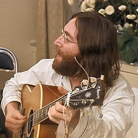 John Lennon playing guitar