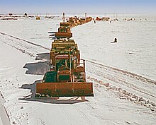 MCB 1 Sled train departing Little America for traverse to Byrd Station (646 miles) or the South Pole (850 miles). The Navy special ordered SD-LGP D8s (SD=stretched dozer, LGP=low ground pressure) with the frames extended 4 feet and tracks 54 inches wide resulting in a ground pressure of 4.30 psi and blades 18.5 feet wide. There were two types of sleds: 10 ton or 20 ton that could be hitched in multiples. (U.S. Navy). MCB 1 Sled train departing Little America for traverse to Byrd Station.jpg