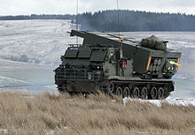 British M270 firing at Otterburn Training Area in 2015 MLRS firing on the ranges at Otterburn. MOD 45158572.jpg