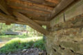 The underside of the bridge showing where the Burr arch meets the concrete bridge abutment. The concrete bridge in the background bypasses this bridge.