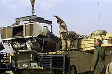 Marines from 1st Tank Battalion load a Honeywell AGT1500 multifuel turbine back into a tank at Camp Coyote, Kuwait, February 2003 AGT1500 engine and M1 tank.JPEG