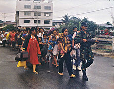 Indonesian military forces evacuate refugees from Ambon during the Maluku sectarian conflict in 1999. Ambon refugees, 1999.jpg