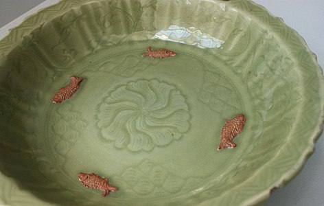 Dish with sprigged fish in biscuit, and effects from glaze collecting in the incised decoration, Yuan, 14th century