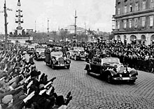 Crowds greet German Chancellor Adolf Hitler as he rides in an open car in Vienna following the March 1938 annexation of Austria by Nazi Germany Bundesarchiv Bild 146-1972-028-14, Anschluss Osterreich.jpg