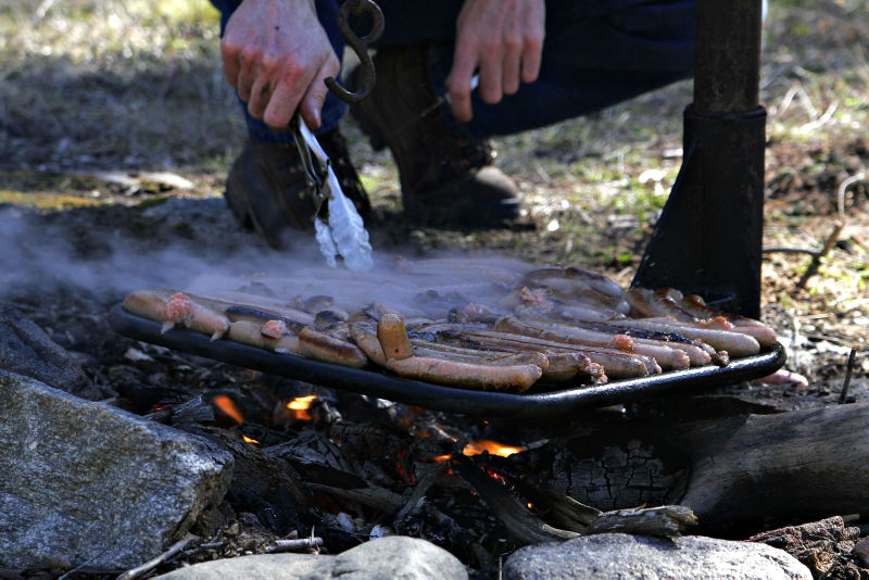 File:Cooking%20snags%20over%20campfire.jpg