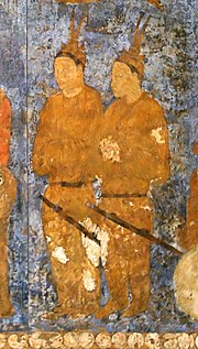 Korean (Goguryeo) ambassadors during an audience with King Varkhuman of Samarkand. They are identified by the two feathers on top of their head. 648-651 AD, Afrasiab murals, Samarkand. Korean ambassadors during a audience with king Varkhuman of Samarkand. 648-651 CE, Afrasiyab, Samarkand.jpg