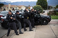 Police officers and U.S. Marshals deputies conducting an arrest in Salinas, California, carrying a variety of weaponry OTB Salinas070.jpg