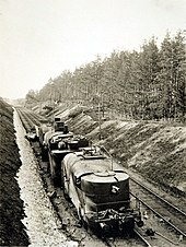 A Russian armoured train, Partizan, is pictured motionless on its tracks. The train is shown to have three cars and a weapon at its front, hidden beneath armour plating. The train assisted the Red war effort in the Vyborg area.