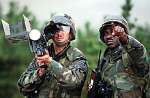 M134 Stinger Tracking Trainer with IFF antenna unfolded Staff Sgt. Warren Jackson points out a target to Stinger anti-aircraft guided missile gunner Sgt. Gary Cross during the air base ground defense Exercise Foal Eagle '89 DF-ST-90-12024.jpg