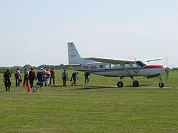 Skydivers walking to a Cessna 208 on Texel