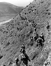 U.S. Marines move out over rugged mountain terrain while closing with North Korean forces. U.S. Marines in the Korean War 003.jpg