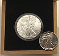 Image 8An American Silver Eagle minted in 2019 (left), an example of a Bullion coin. Its obverse design is based on the older, formerly circulating silver Walking Liberty half dollar (right). (from Coin)