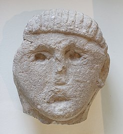 Head of statue with an oak crown found near the amphitheater of Lutece, probably representing a member of the royal family or a god (2nd century AD)