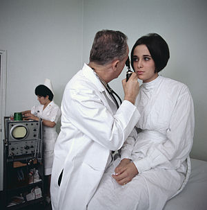 A doctor examines a female patient.