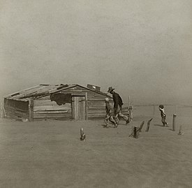 Farmer and sons in dust storm, 1936
