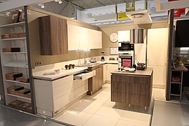 This kitchen features varied wall cabinets for aesthetic reasons.