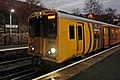 A Merseyrail Class 508 waits at the station.