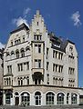 Trier, Porta-Nigra-Platz 5: repräsentatives viergeschossiges Eckwohn- und Geschäftshaus, historisierender Putzbau, bezeichnet 1905, Architekten Julius Wirtz und Wilhelm Schmitz