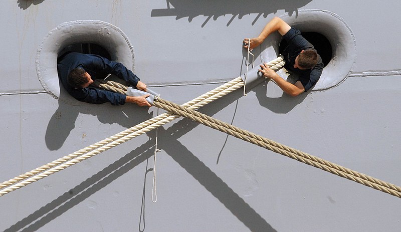 File:US Navy 080310-N-3289C-226 ailors install rat guards to mooring lines as the amphibious assault ship USS Iwo Jima (LHD 7) moors pier side at Naval Station Rota.jpg
