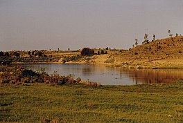 A small lake, with sandy banks