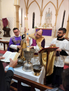 The blessing of the Easter water with the Paschal candle Blessing of the Easter Water with the Paschal Candle.png