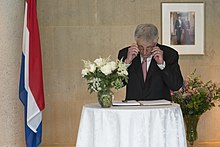 United States Secretary of Defense Chuck Hagel signs a condolence book in the Netherlands embassy in Washington D.C. Chuck Hagel signs condolence book MH17 (2).jpg