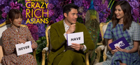 Constance Wu, Henry Golding, and Gemma Chan hold white cards with "never" and "have" on them