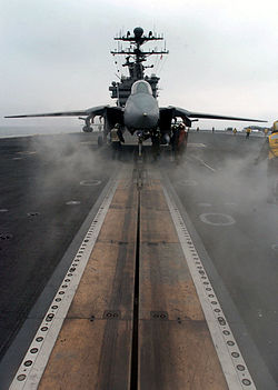 An F-14D Tomcat sits poised for launch on one of four steam-powered catapults aboard the nuclear powered aircraft carrier USS John C. Stennis.