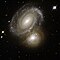 Interagujúce galaxie, záber z Hubbleovho vesmírneho ďalekohľadu. Táto dvojica galaxií vzdialená 350 miliónov svetelných rokov sa gravitačne navzájom deformuje.