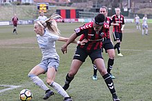 Kelly (left) pushes off a Lewes FC defender, 2018 Lewes FC Women 0 Everton Ladies 6 FAC 6th Rd 18 02 2018-838 (39655848854).jpg