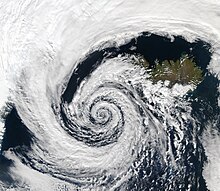 Very large air masses (and the clouds within them) spiral counterclockwise around a strong center of low atmospheric pressure in this extratropical cyclone over Iceland Low pressure system over Iceland.jpg