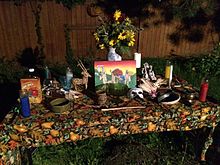 Mabon-fall equinox 2015 altar by the Salt Lake Pagan Society of Salt Lake City, Utah. Displayed are seasonal decorations, altar tools, elemental candles, flowers, deity statues, cookies and juice offerings, and a nude Gods painting of Thor, the Green Man, and Cernunnos dancing around a Mabon Fire. Mabon-Fall Equinox 2015 Altar by the Salt Lake Pagan Society, Salt Lake City, UT.jpg