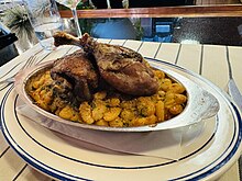 A photograph of cassoulet in a metal dish.