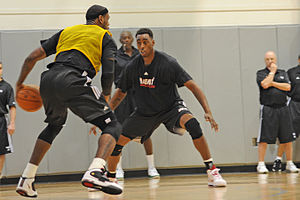 NBA player LeBron James (left) prepares to tak...