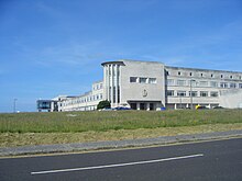 a long four-floor grey building on Portland