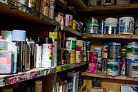 A collection of cans of :en:paint and other re...