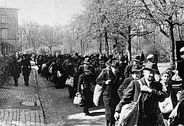 Jews are deported from Wurzburg, 25 April 1942. Deportation occurred in public and was witnessed by many Germans. Jews deported from Wurzburg march down the Hindenburgstrasse from the Platzscher Garten to the railroad station.jpg