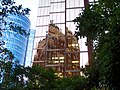 The building is reflected in several modern glass skyscrapers surrounding the Marine Building.